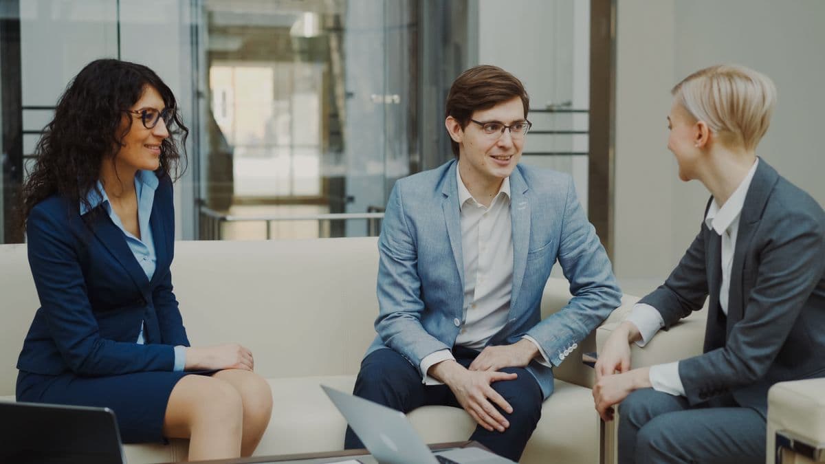 Three business professionals in a collaborative discussion